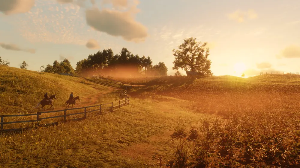 Red Dead Redemption 2: jeźdźcy na złocistej prerii w świetle zachodzącego słońca